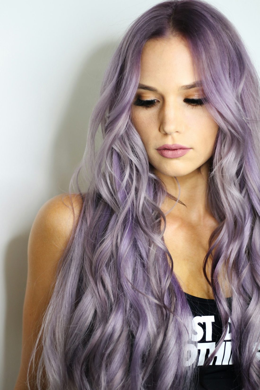 Portrait of a woman with long lavender vivid color in soft waves