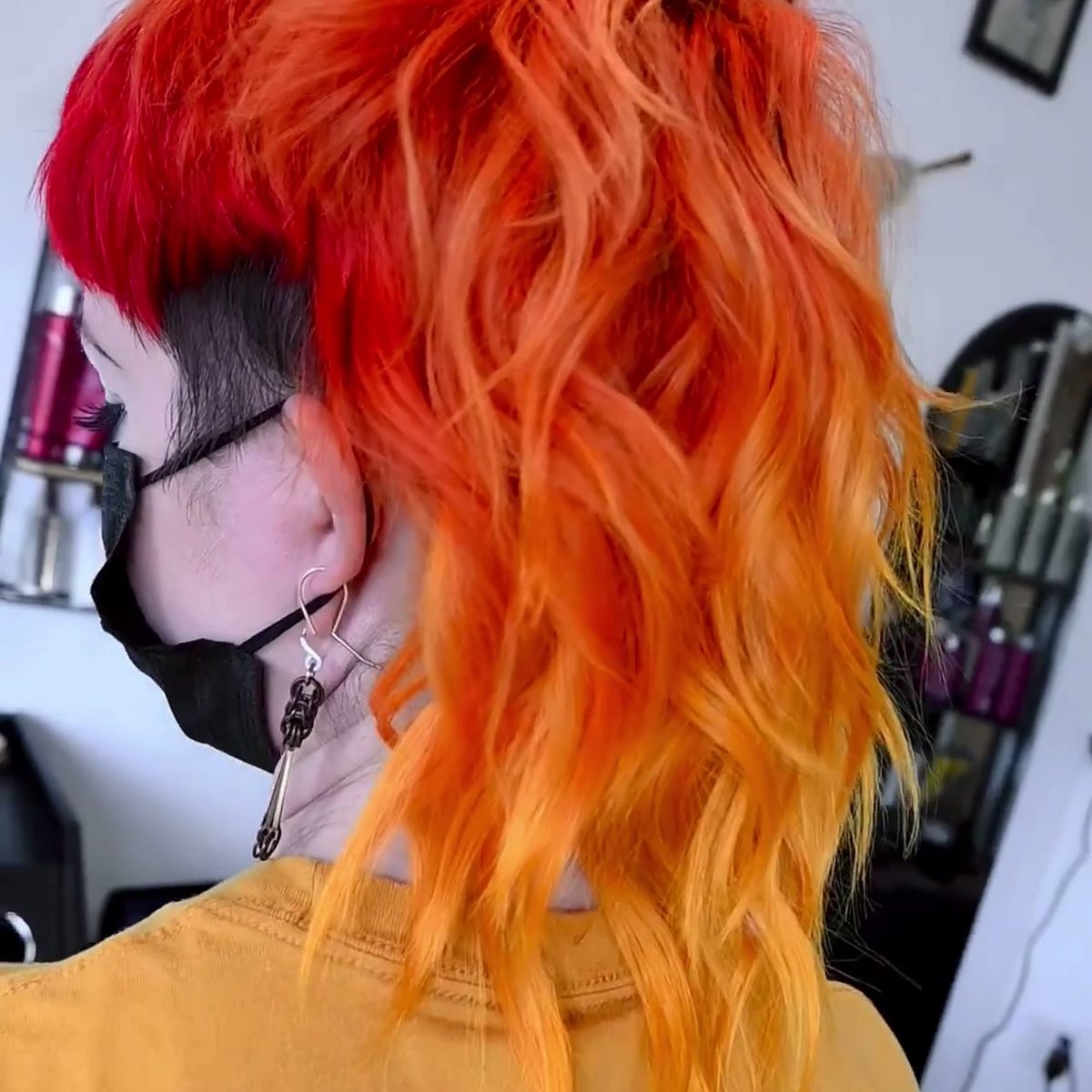 Copper and orange creative color with a shaved side detail, created in this suite